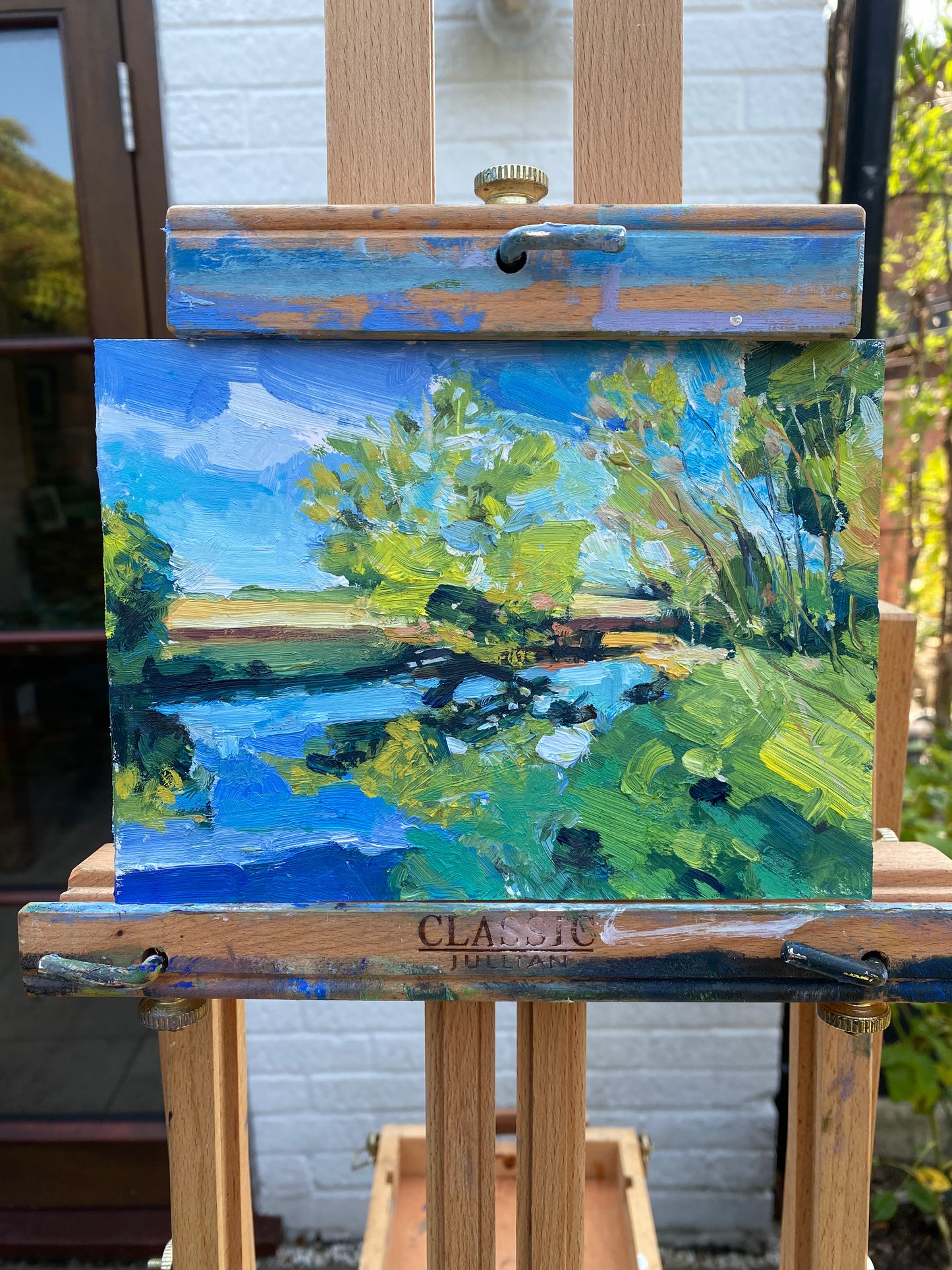 Blue Skies and Ochre Fields Along The River